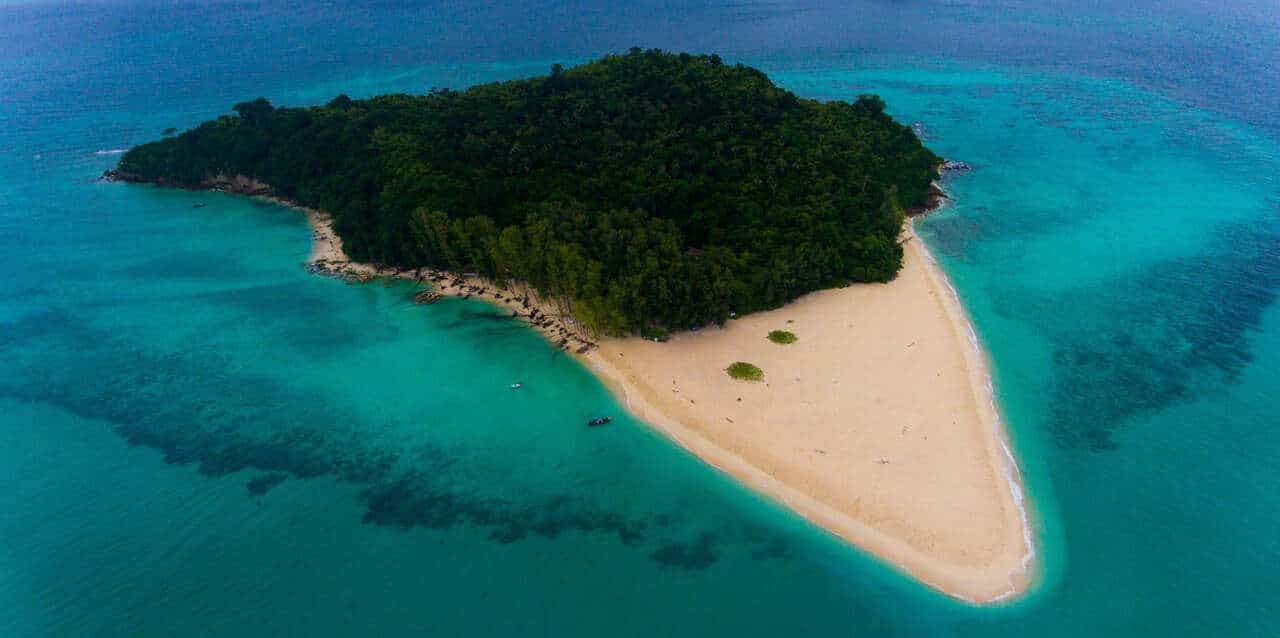 The featured image for our Bamboo Island tour at Sunrise with the island seen from drone above.